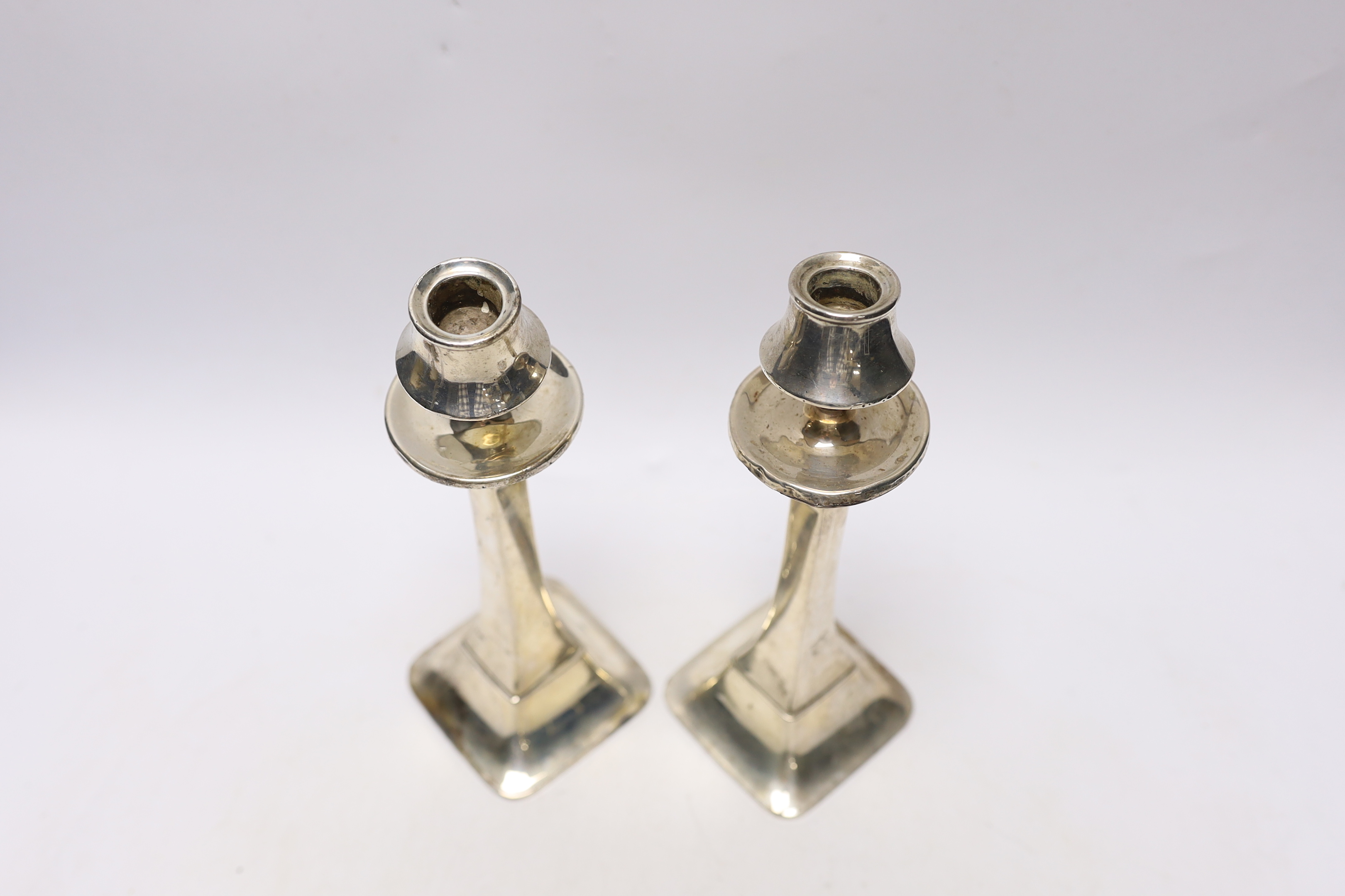 A pair of George V silver candlesticks, of tapering form, Charles S. Green & Co, Birmingham, 1924/25, height 22.5cm, weighted, (a.f.)
